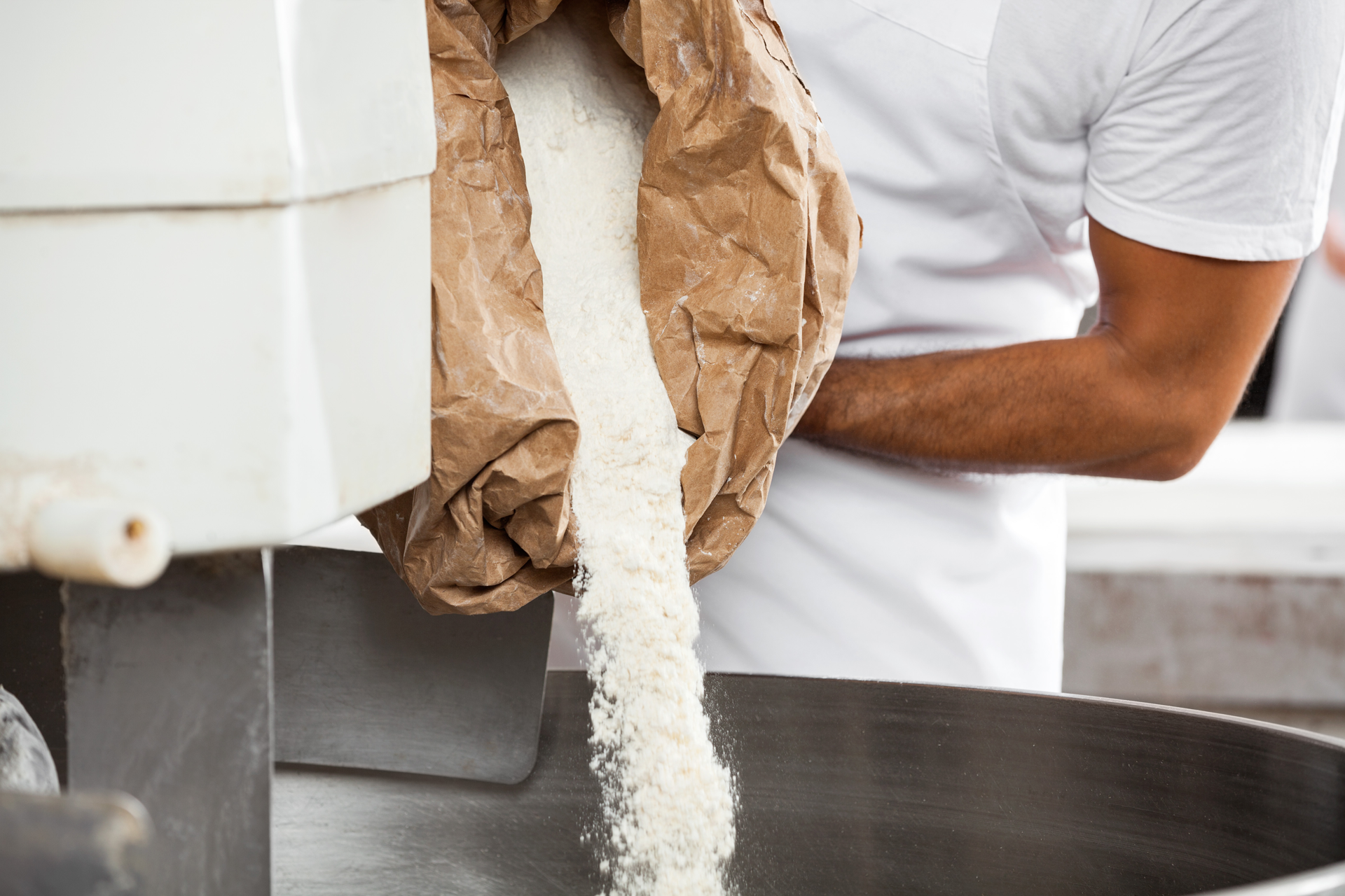 Pouring flour into kneading machine 