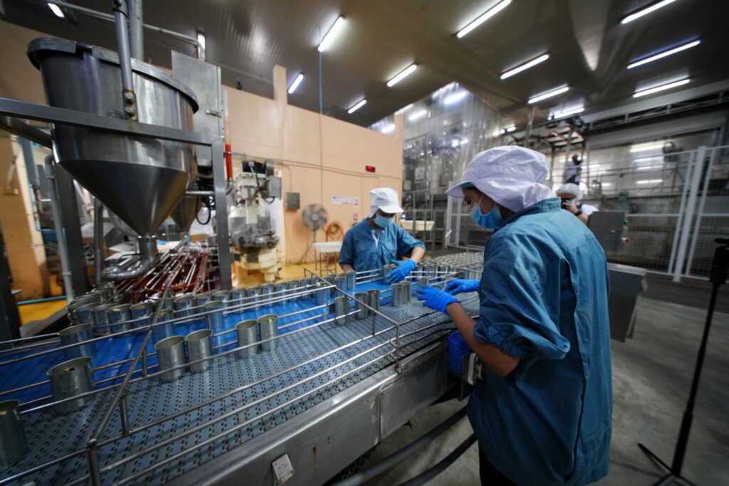 Workers in a food production plant preparing for SQF edition 10 release